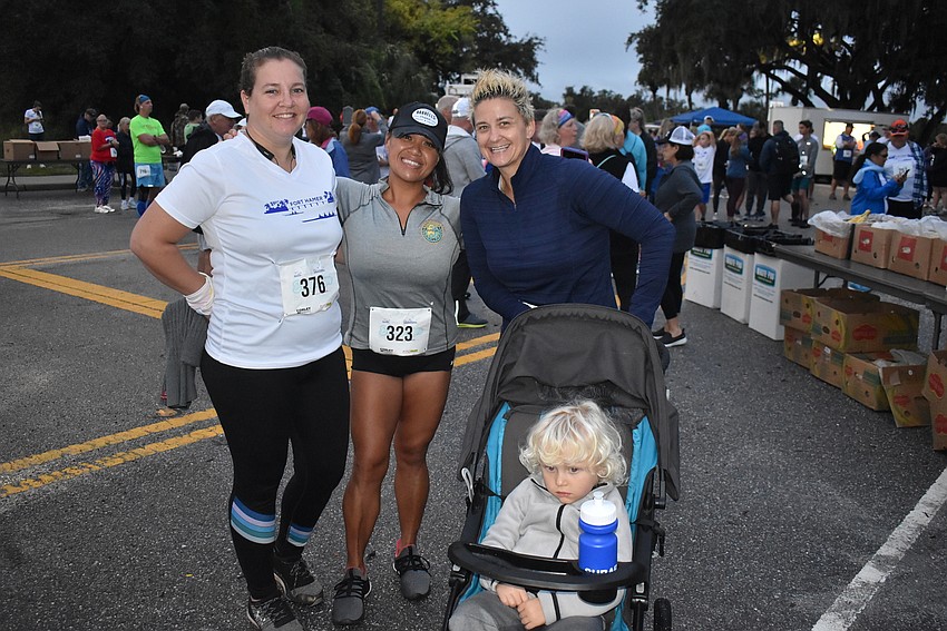 Joan Chirco, Vivien Bazelais, and Cassie Amato, all of Bradenton, get ready for Saturday's run. Bazelais and Amato were teaming up to push Dominic Gallagher (front) in a stroller for the 5K race.