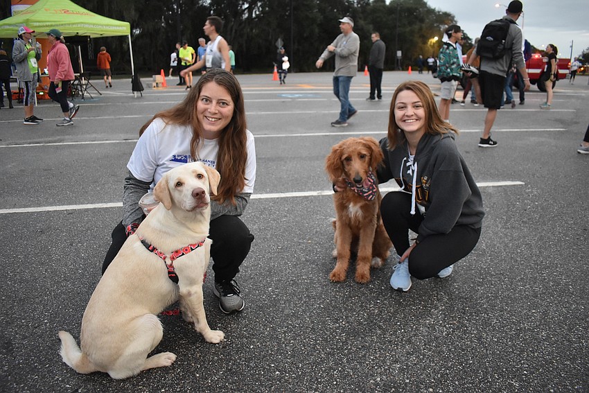 Susannah Philipp and her dog Delilah (left), and Courtney Hartmann and her dog Wesley, all of Parrish, get set to take part in Saturday's Fort Hamer Bridge Run.
