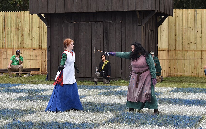 Human chess players duke it out in the battle between Scotland and England at the Medieval Fair on Saturday.