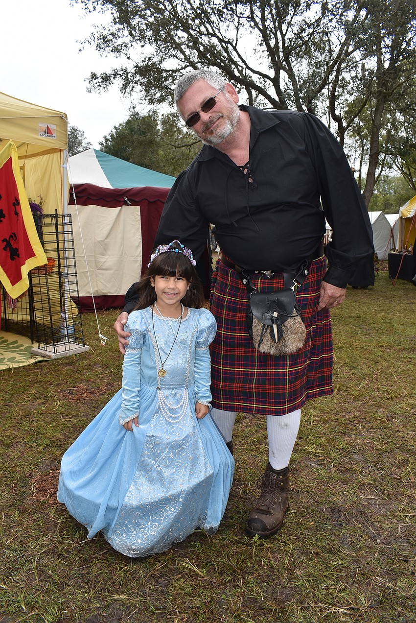 Adalynn Singh (left) and John Taylor, both of Port Charlotte, make their way through the Woods of Mallaranny at the Medieval Fair on Saturday.
