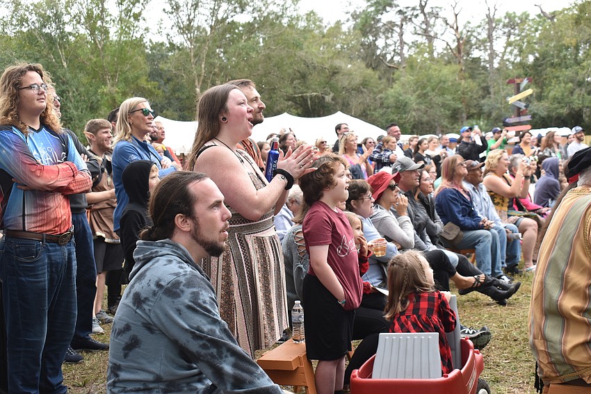 Onlookers watch in awe as performers brave the Wheel of Death at the Sarasota Medieval Fair.