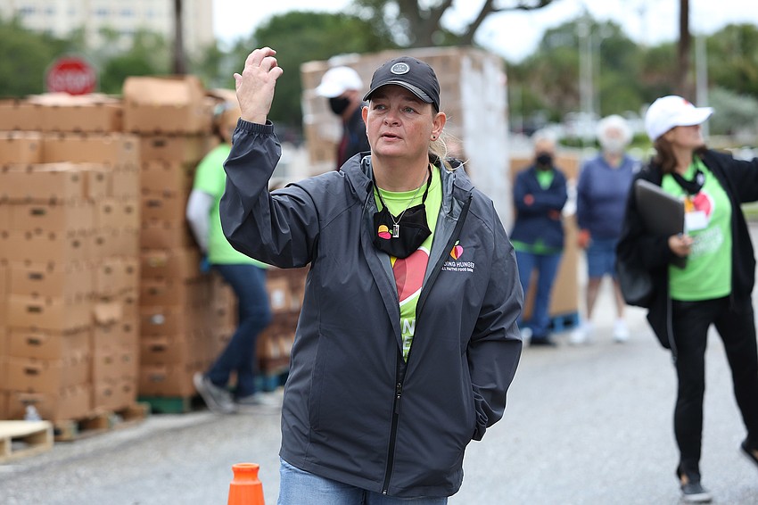 Michelle Collins waves cars over.