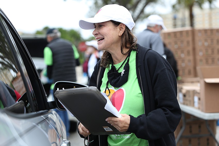 Laura Feder welcomes a visitor.