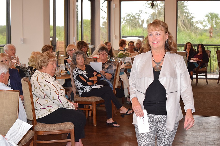 Robin Ambrose lets the crowd get a good look at the fashion she is wearing.