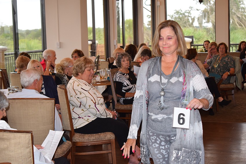 Amber Browne displays the No. 6 so those who attend can find the fashion on sheets provided to them.