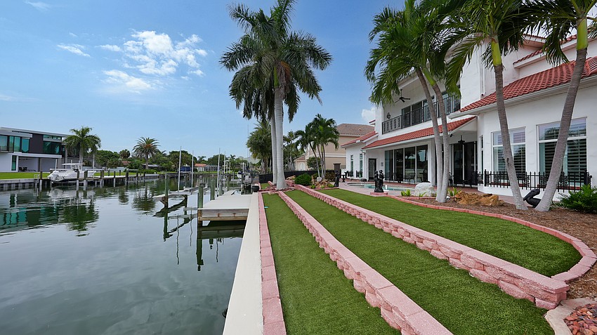The home offers 100 feet of water frontage and a deep water dock.