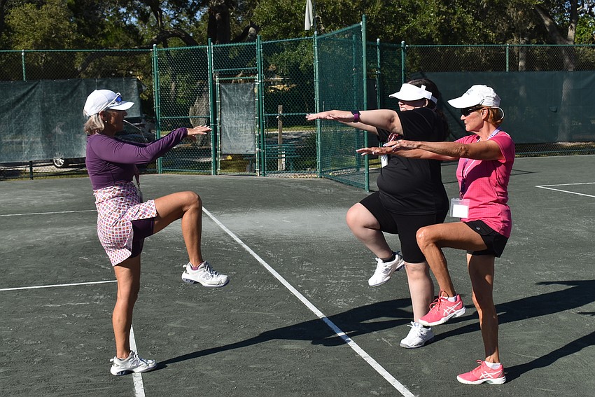 Tamara Wright, Bryanna Schmidt and Chris Goodwin warm up.
