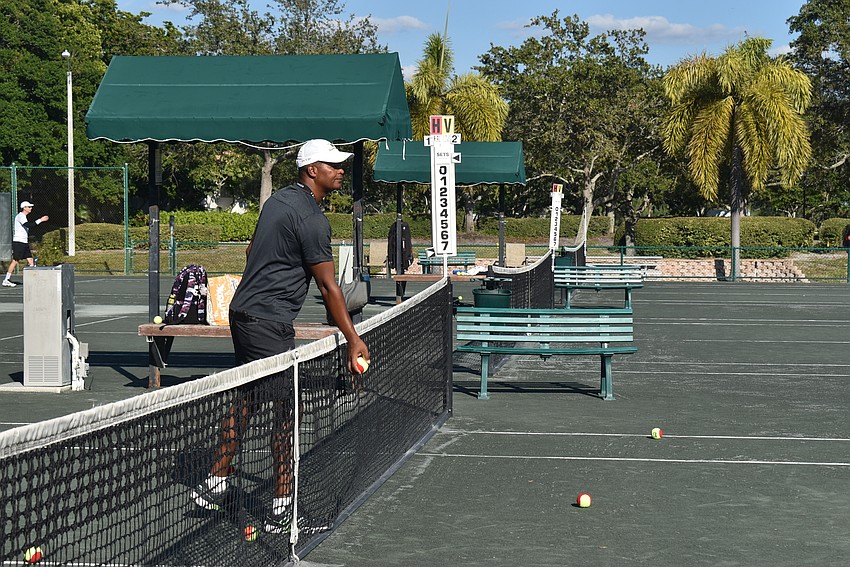 Ron Shields feeds Bryanna Schmidt a ball.