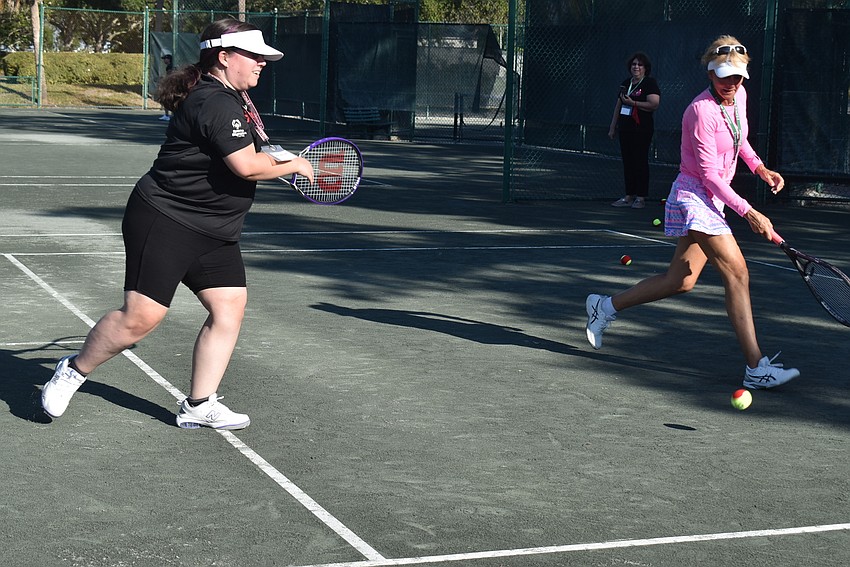 bryanna Schmidt and Brenda Terihay run for a ball.