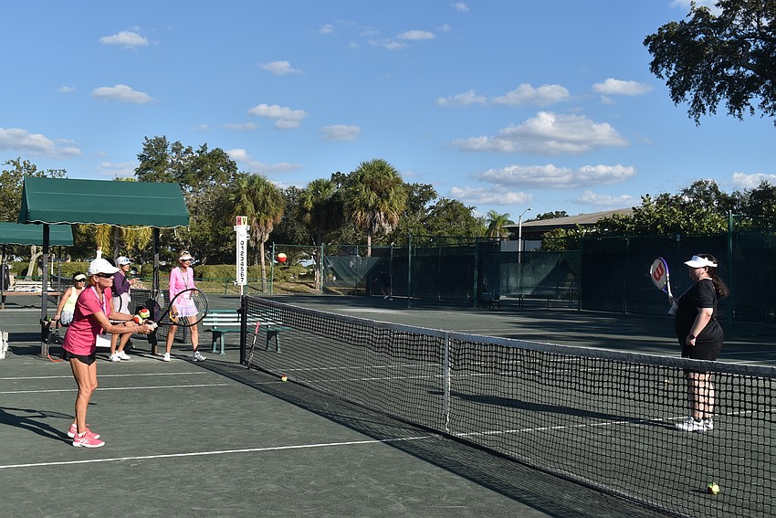 Chris Goodwin feeds Bryanna Schmidt a ball across the net.