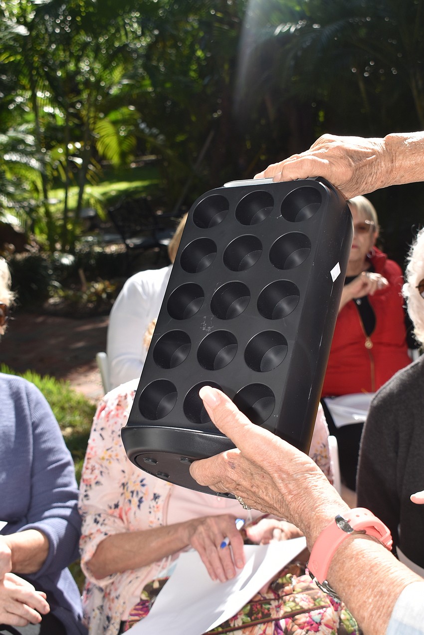Lesley Rife shows off a mystery item that wound up being a Keurig pod holder.