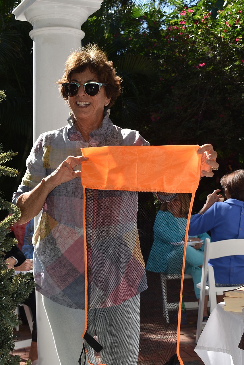 Lesley Rife has attendees guess the item, which is a net that turns a pool noodle into a seat.