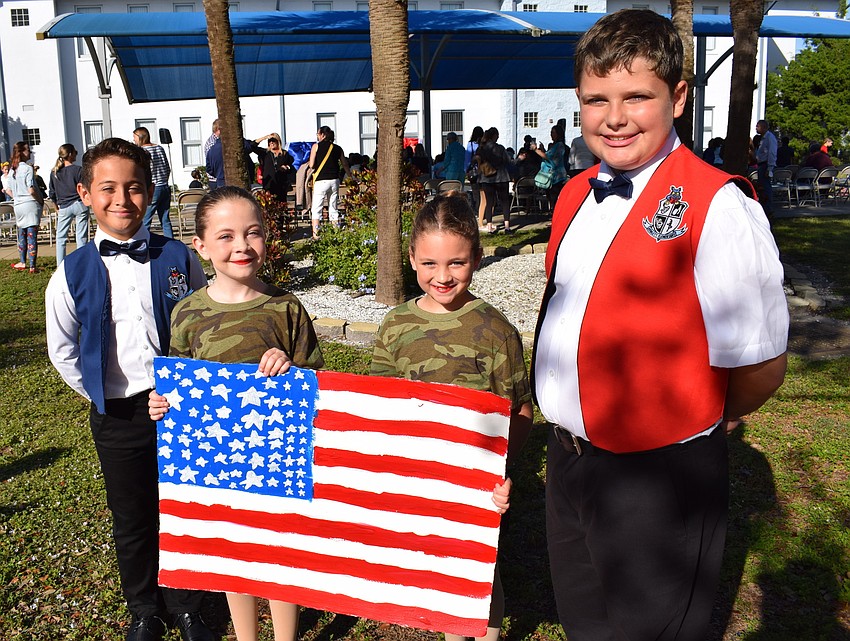 Fourth grader Emmanuel Cortes-Alban and fifth graders ReAnn Kolbe, Lillian Chandler and Noah LaBarr are all East County residents who attend Rowlett Academy. They participated in a special Veterans Day ceremony on Nov. 10.