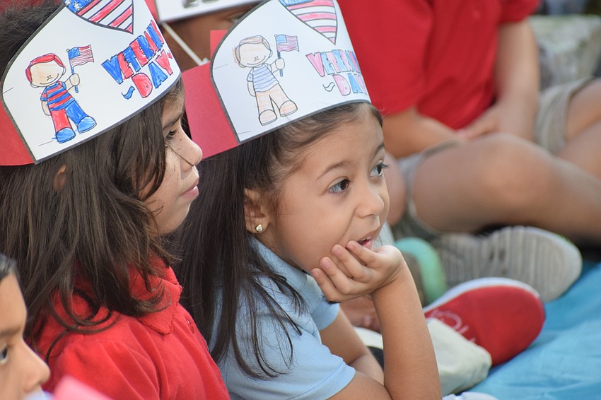 Kindergarten students Avalina Manapat and Frida Robles Mares enjoy the show.