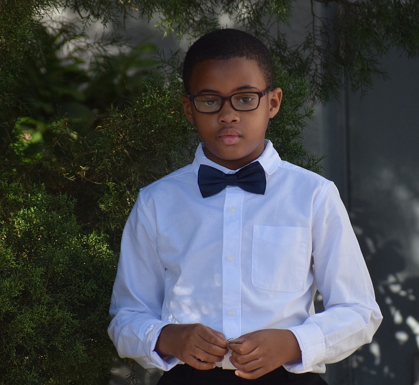 Rowlett Academy fourth grader Jaylon Clark is looking dapper before a ceremony to honor veterans.