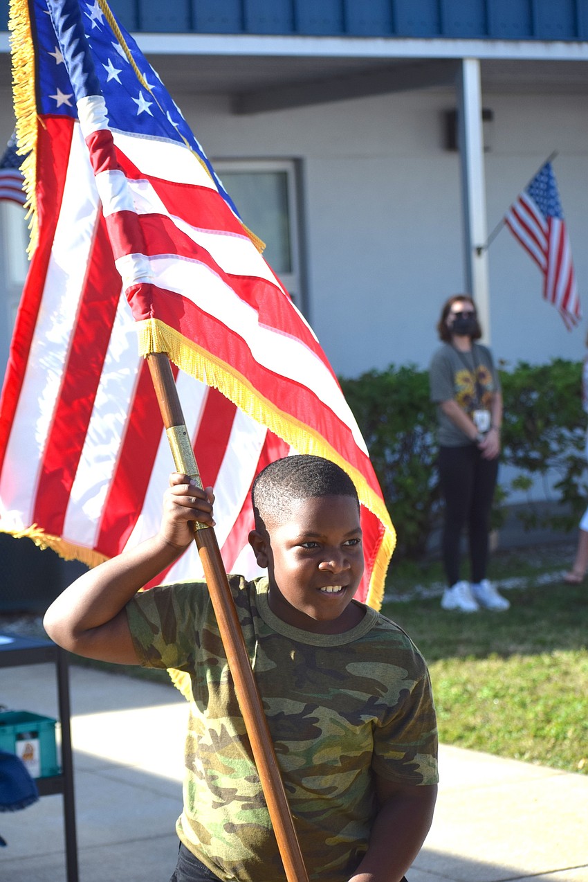 Fifth grader Isaiah Burch presents the colors during a Veterans Day ceremony at Rowlett Academy on Nov. 10.