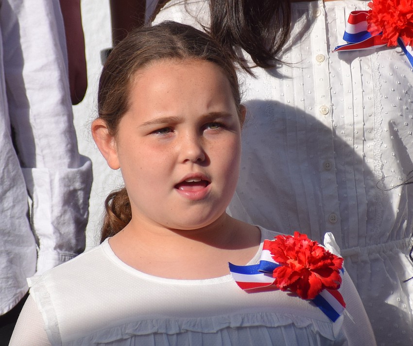 Fifth-grader Alana Perry sings with the chorus.