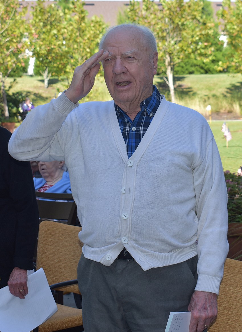 Lew Keyser, a Navy veteran, salutes the American flag during the Nov. 10 ceremony honoring veterans at The Sheridan in Lakewood Ranch.
