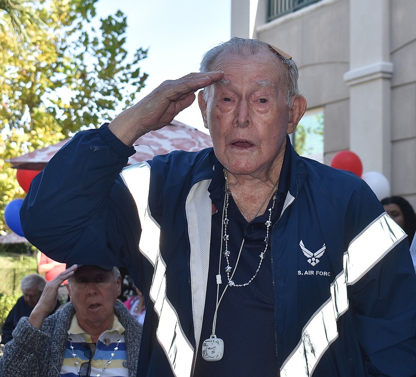 Air Force veteran Richard Sutton salutes the American Flag during the playing of the Star Spangled Banner during the Veterans Day ceremony Nov. 10 at The Sheridan in Lakewood Ranch.