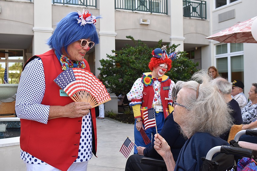 Tidewell Hospice clown Anita Smiles gets a laugh from The Sheridan resident Belle Berger (right) during the November 10 ceremony.