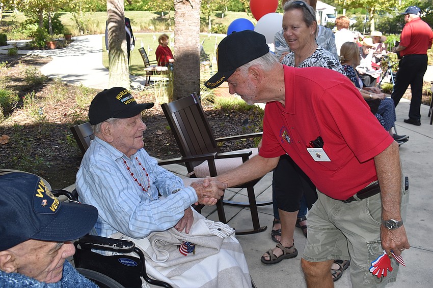 Tom Ludwig (right) from the Knights of Columbus greets World War II Air Force veteran Ben Packer during a Veteran's Day celebration at The Sheridan in Lakewood Ranch.