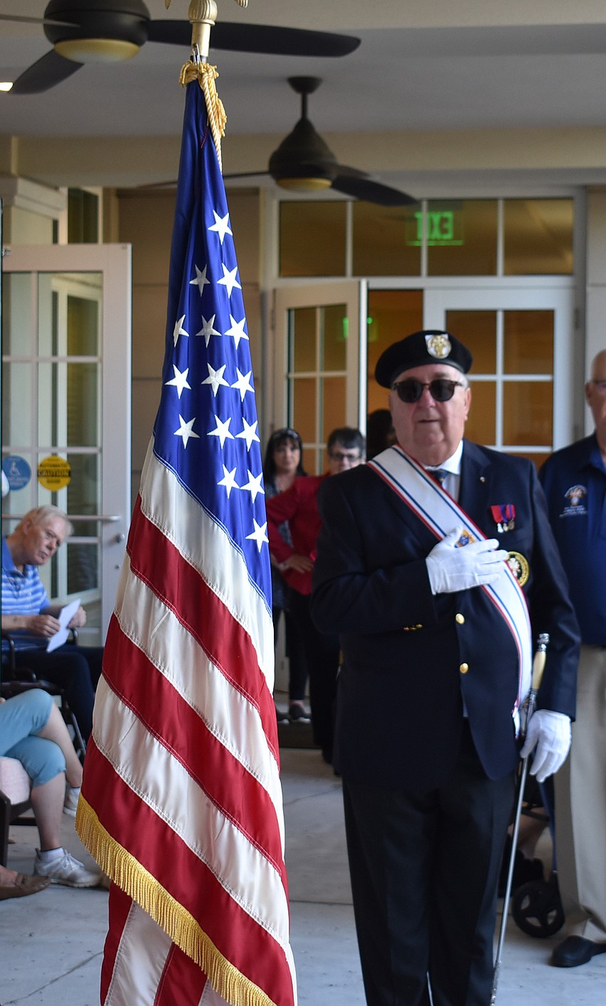 Chris Treston, Color Core of the Knights of Columbus, presents the American flag at the start of the November 10 celebration at The Sheridan in Lakewood Ranch.