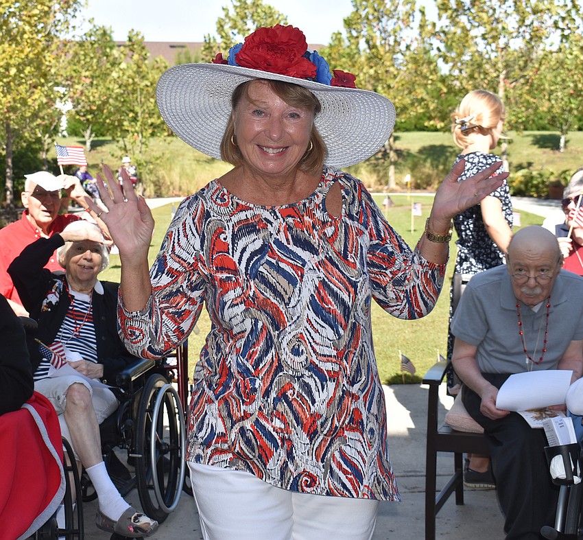 Regina Joly works her way through the crowd, drawing smiles and a waves from Sheridan residents during a November 10 ceremony to honor veterans.