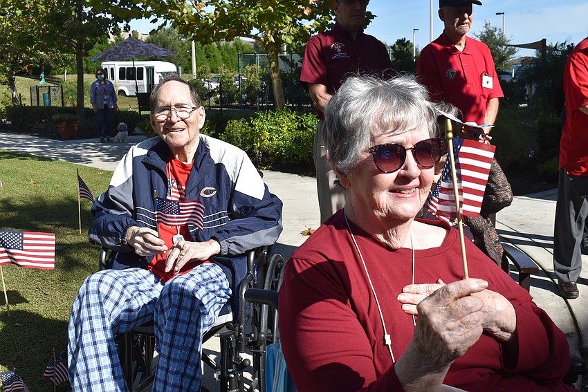 Bob and Cathy Frazier wave their flags as patriotic music plays during the Veterans Day celebration at The Sheridan in Lakewood Ranch. Bob Frazier is an Air Force veteran who served in the Korean War.