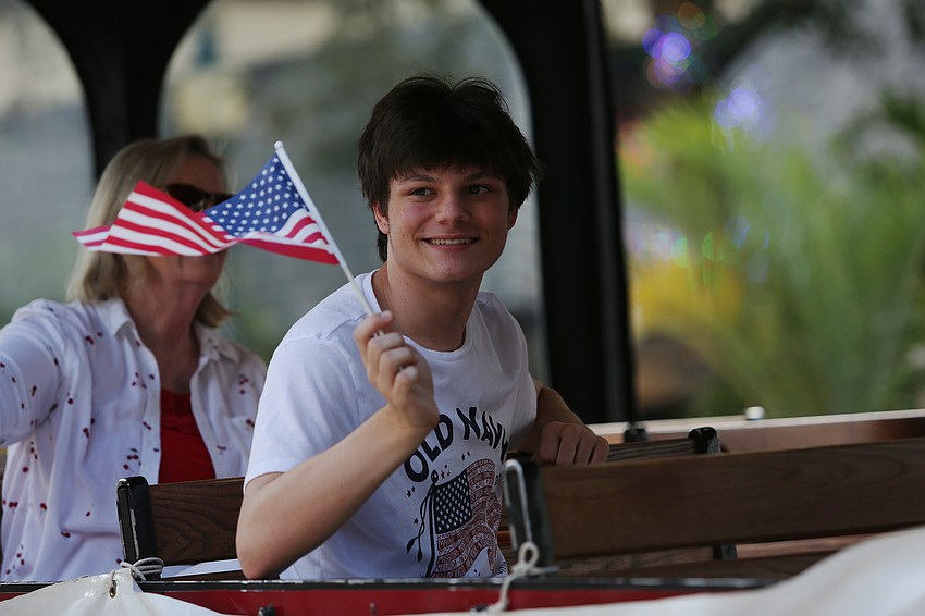 Austin Selmer waves from the Sons of the American Revolution vehicle.