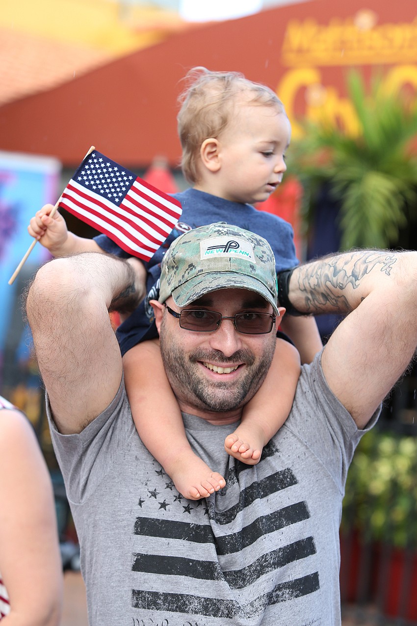 Cosmo and Gabriel Cordiallini cheer on the parade.