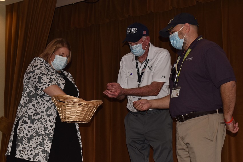 Stacy Groff, Terry Purcell and Brian Preston gather pins for veterans.