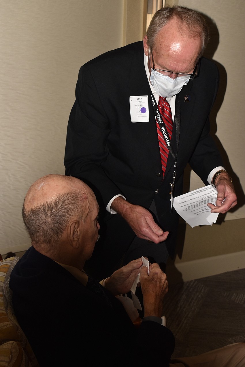 John Joly from Tidewell prepares to attach another pin.