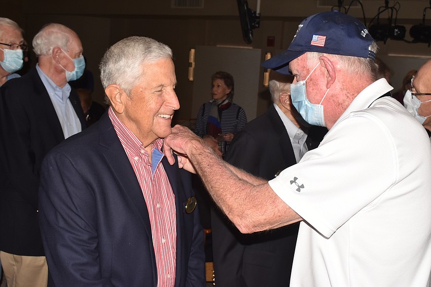 Gary Olsen receives a pin from Terry Purcell.