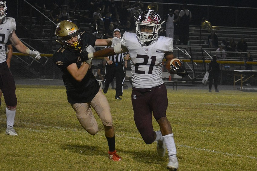 Nehemiah Jenkins stiff arms Countryside senior Dylan Cassidy.