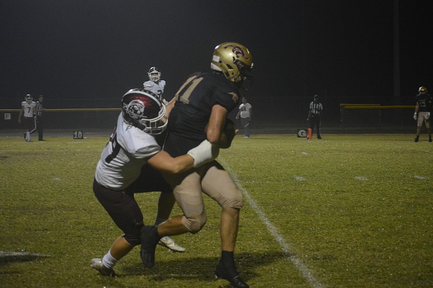 Pirates senior Tyler Ricker brings down Countryside senior tight end Carson Burbee.