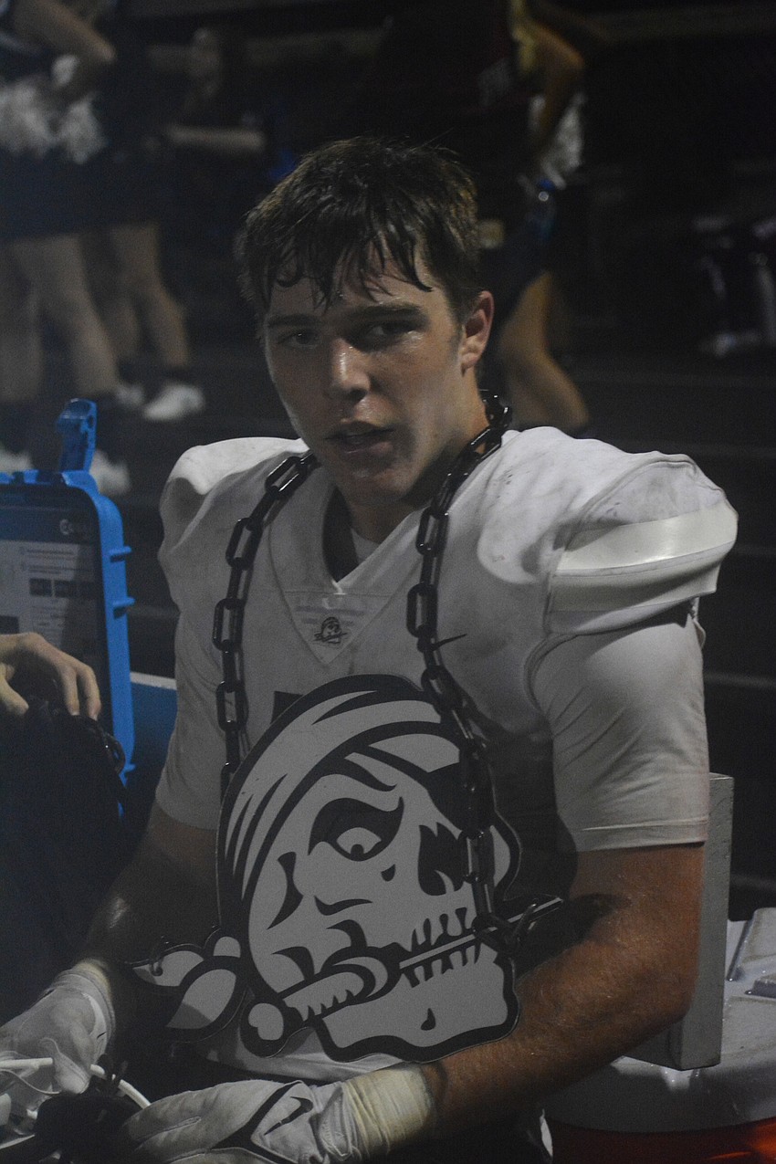 Junior linebacker Aidan Dangler wears the Pirates' turnover chain after snagging a fourth-quarter interception.