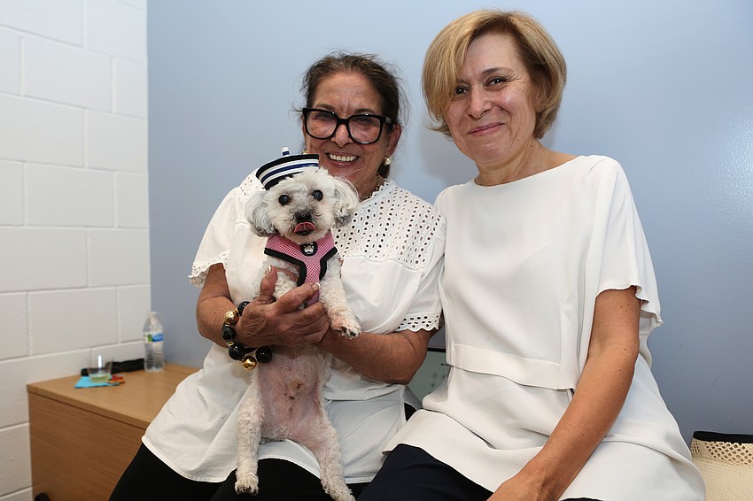 Judy Herman and Irina Deynega bring Mimo the dog