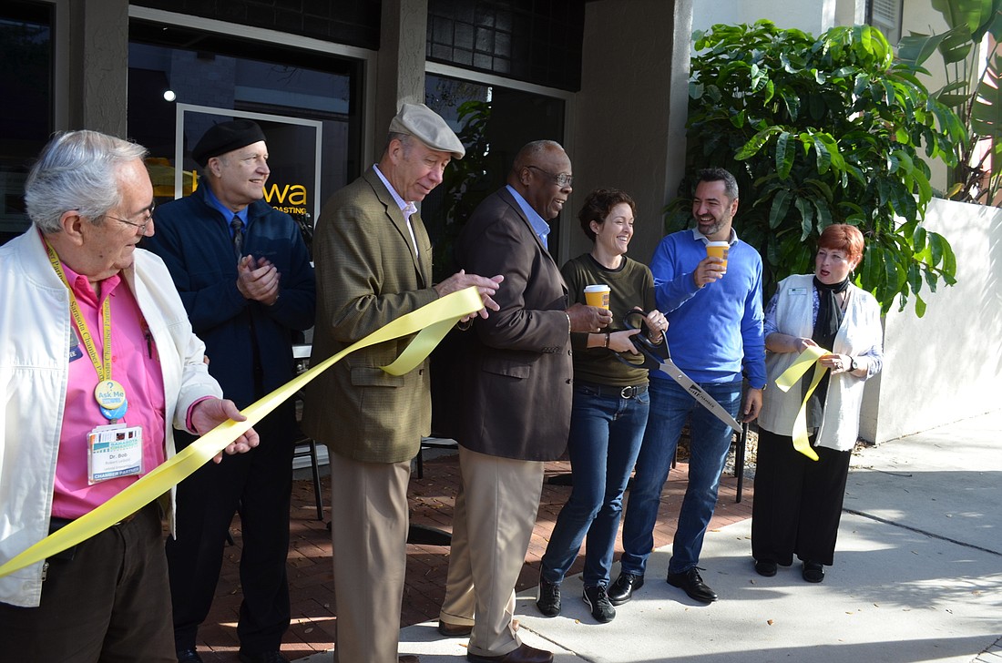 Representatives from the Greater Sarasota Chamber of Commerce and the city of Sarasota helped Kahwa Coffee co-owners Sarah and Raphael Perrier cut the ribbon during the shop's grand opening Wednesday.