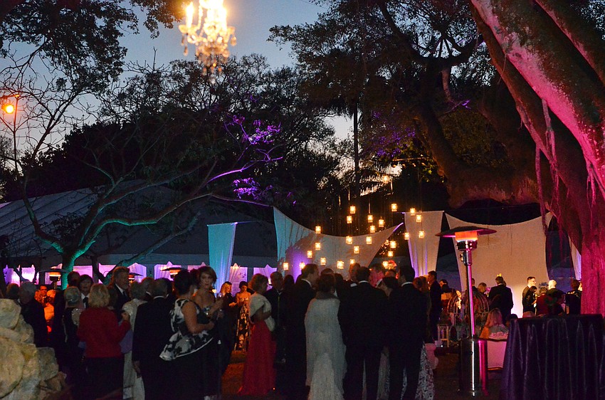 Guests gathered in the gardens for cocktail hour during The 2016 Orchid Ball.
