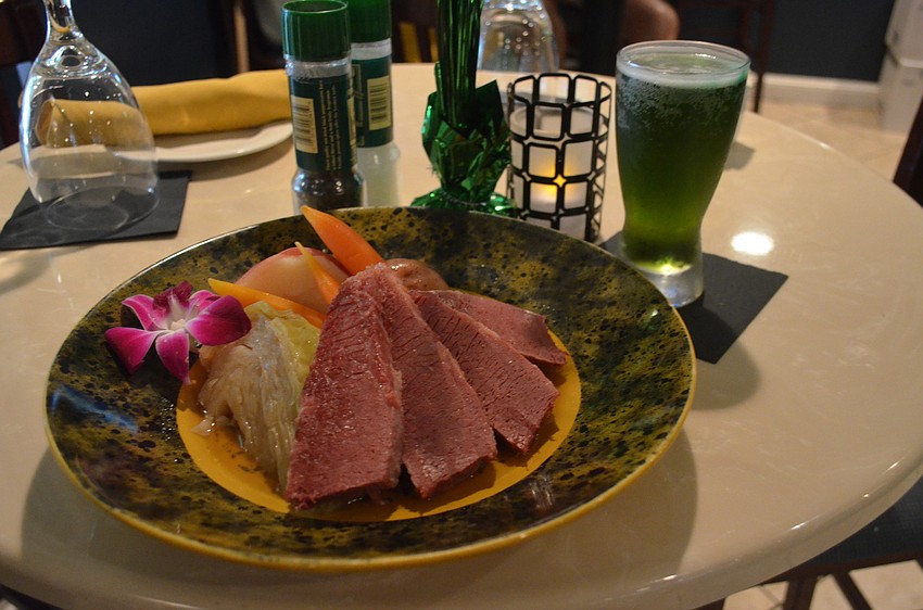 The restaurant served corned beef and cabbage with green beer.