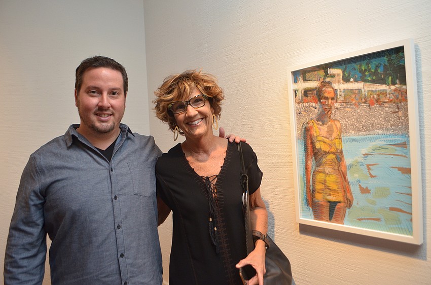 Tim Jaeger and Barbara Banks stand with the painting Jaeger created based off a photo of Banks’ mother, Betty.