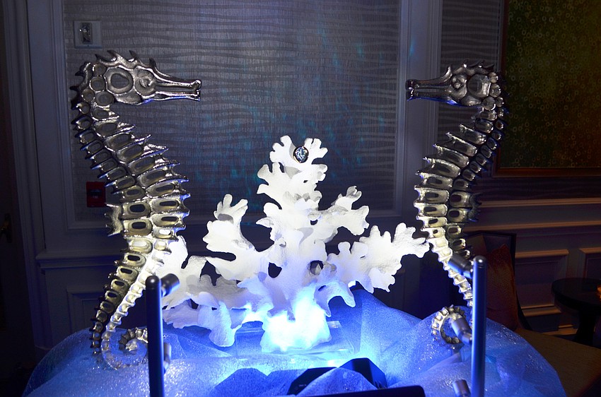 Diamond Vault created a custom convertible brooch/pin with 18 KT yellow and white gold, 37 diamonds in the shape of a piece of coral, and blue topaz. Attendees had the opportunity to buy raffle tickets for the chance to win the piece.