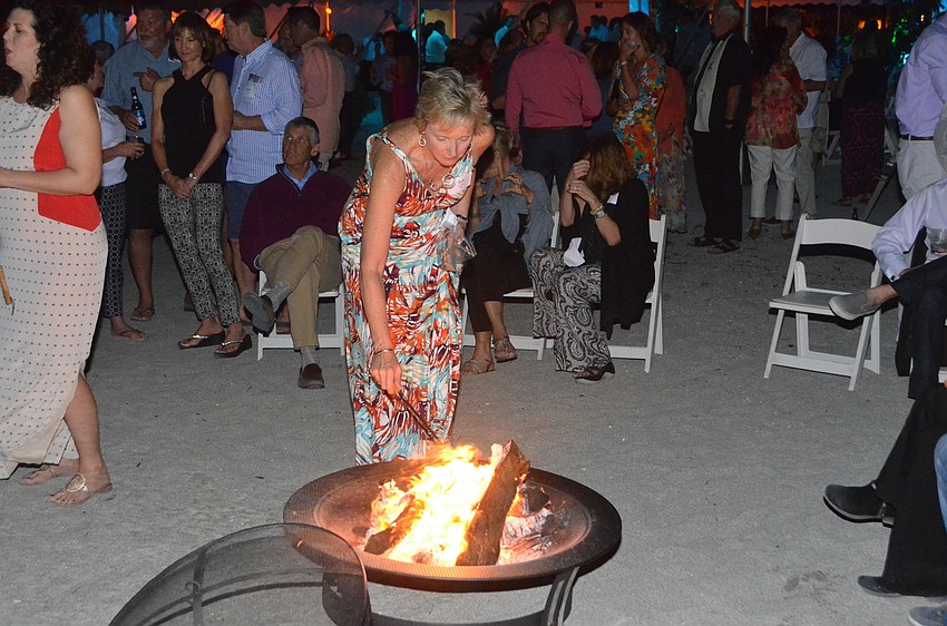Salli Struble roasts a marshmallow over the bonfire after dinner.