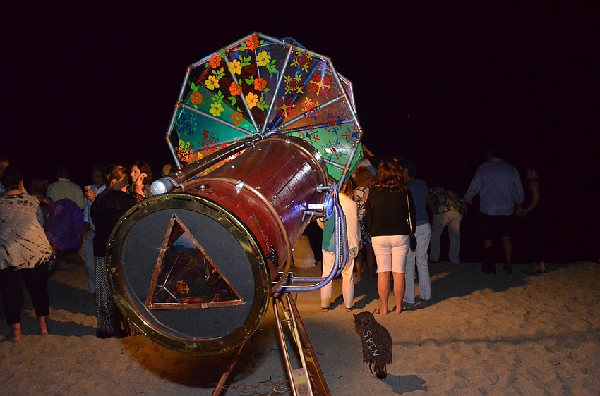 A kaleidoscope made by Josh Kuse sits amongst the crowd during the bonfire.