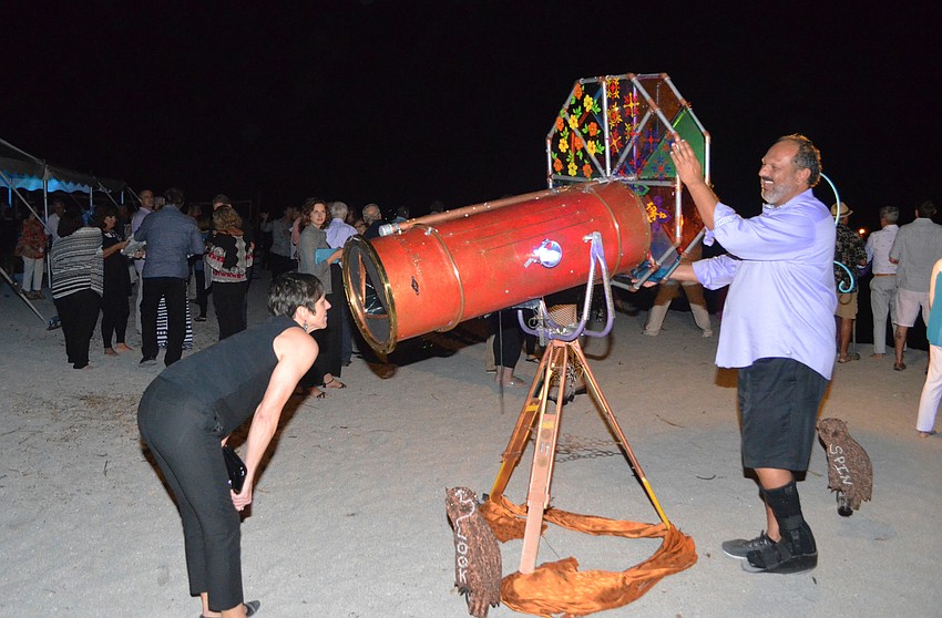 Children First CEO Philip Tavill spins the kaleidoscope for Dana Duckman.