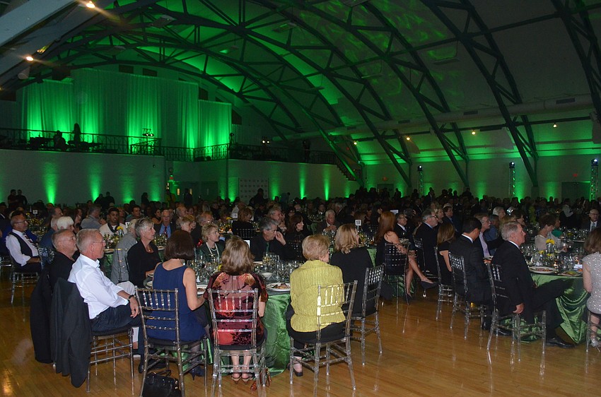Honorees watch the award presentation under a sea of emerald lights.