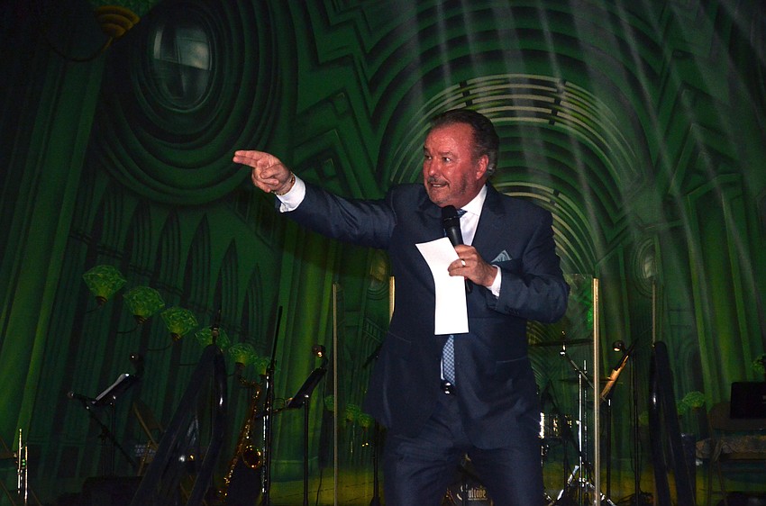 Michael Klauber points at a bidder during the live auction.