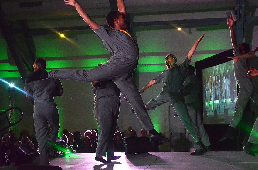 Dancers leap during an excerpt of “The Wiz” performed for Emerald City Ball guests.