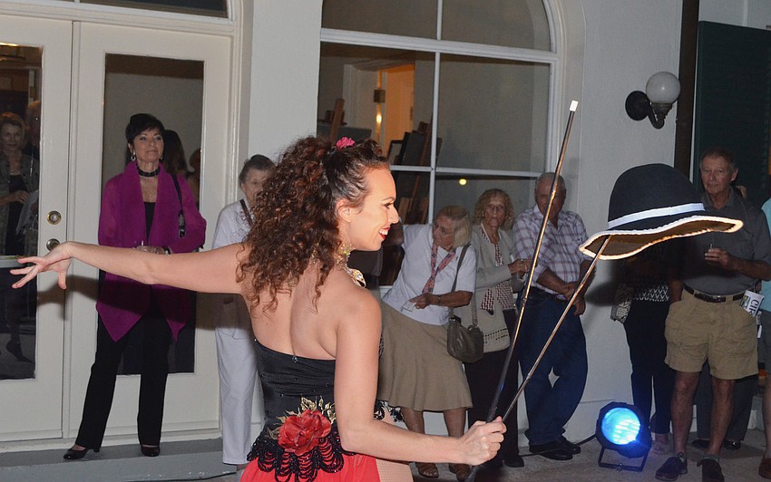 Gena Cristiani juggles a hat for the crowd.