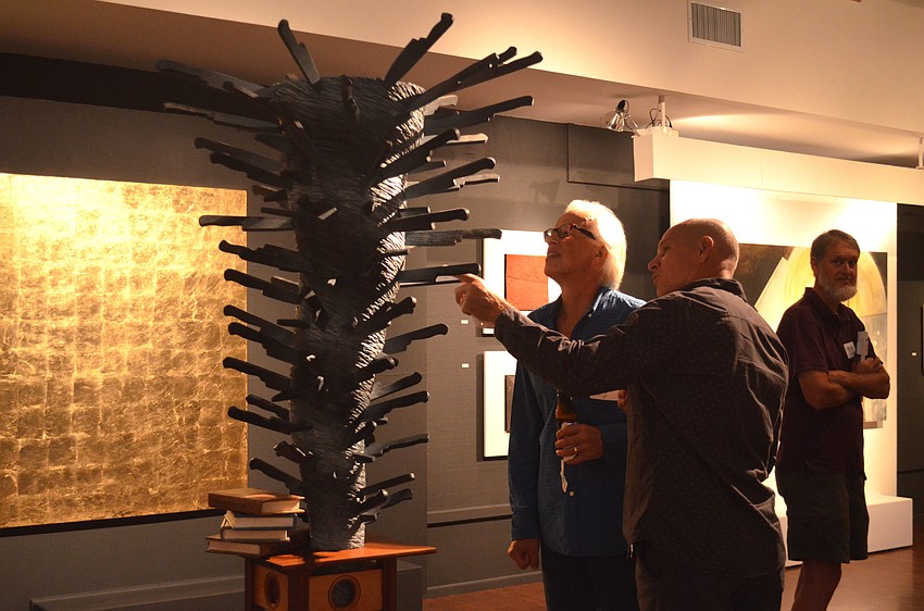 Rod Johnson and Sean Moloney check out “At the Center of the Cyclone; Tap Dancing through a Storm of Knives.”